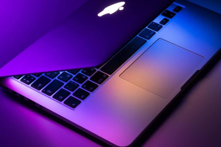 Half folded MacBook with purple lighting